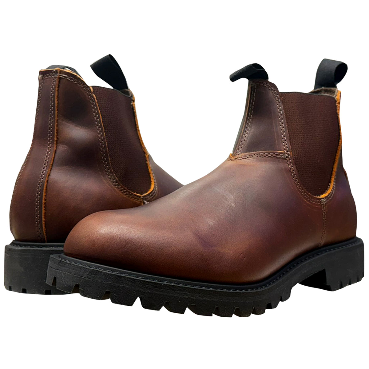 A pair of dark brown leather Chelsea boots with black elastic side panels and black lug soles, shown on a plain white background.