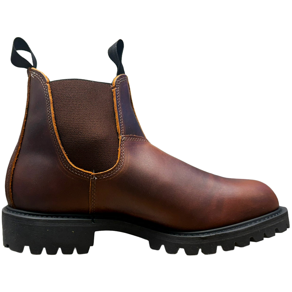 A brown leather Chelsea boot with black elastic side panels, pull tabs, and a rugged black lug sole, shown in a side profile on a white background.