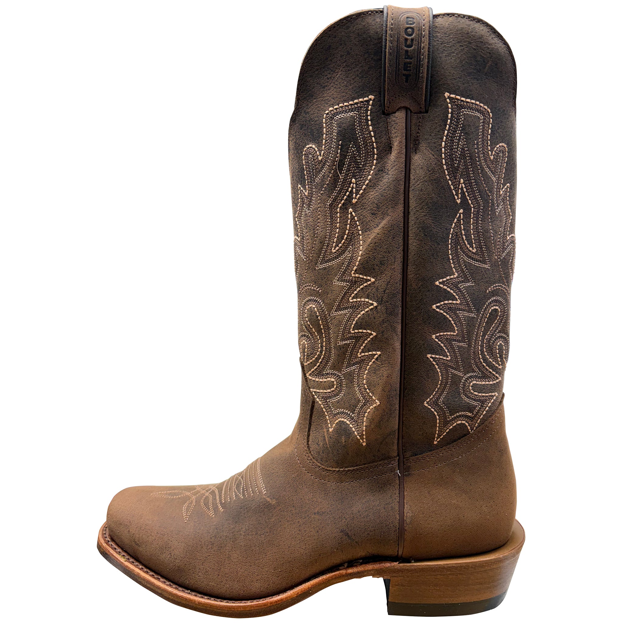 Brown cowboy boot with intricate stitching on a white background