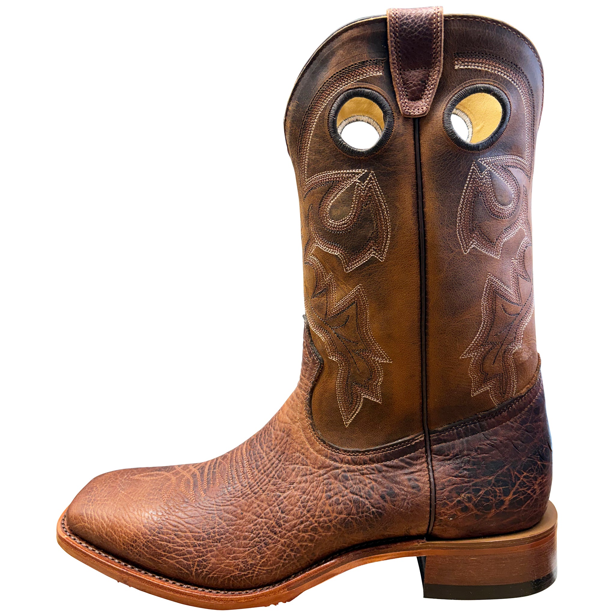 Brown cowboy boot with intricate leatherwork on a white background