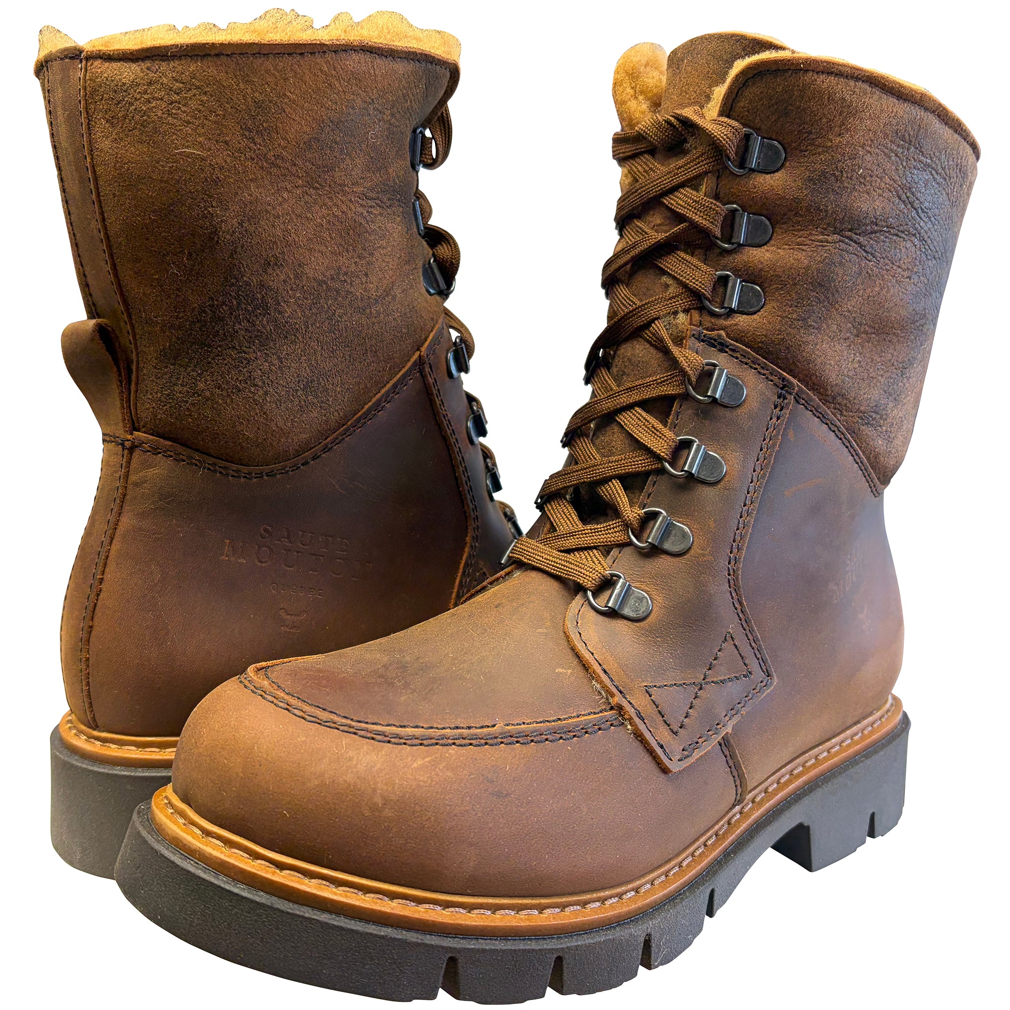 Pair of brown leather boots with black soles on a white background