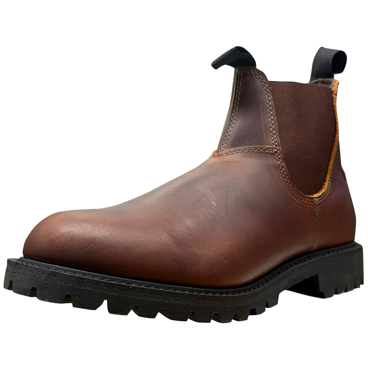 A brown leather Chelsea boot with a black elastic side panel, pull tab, and rugged black lug sole, shown from a three-quarters angle on a white background.