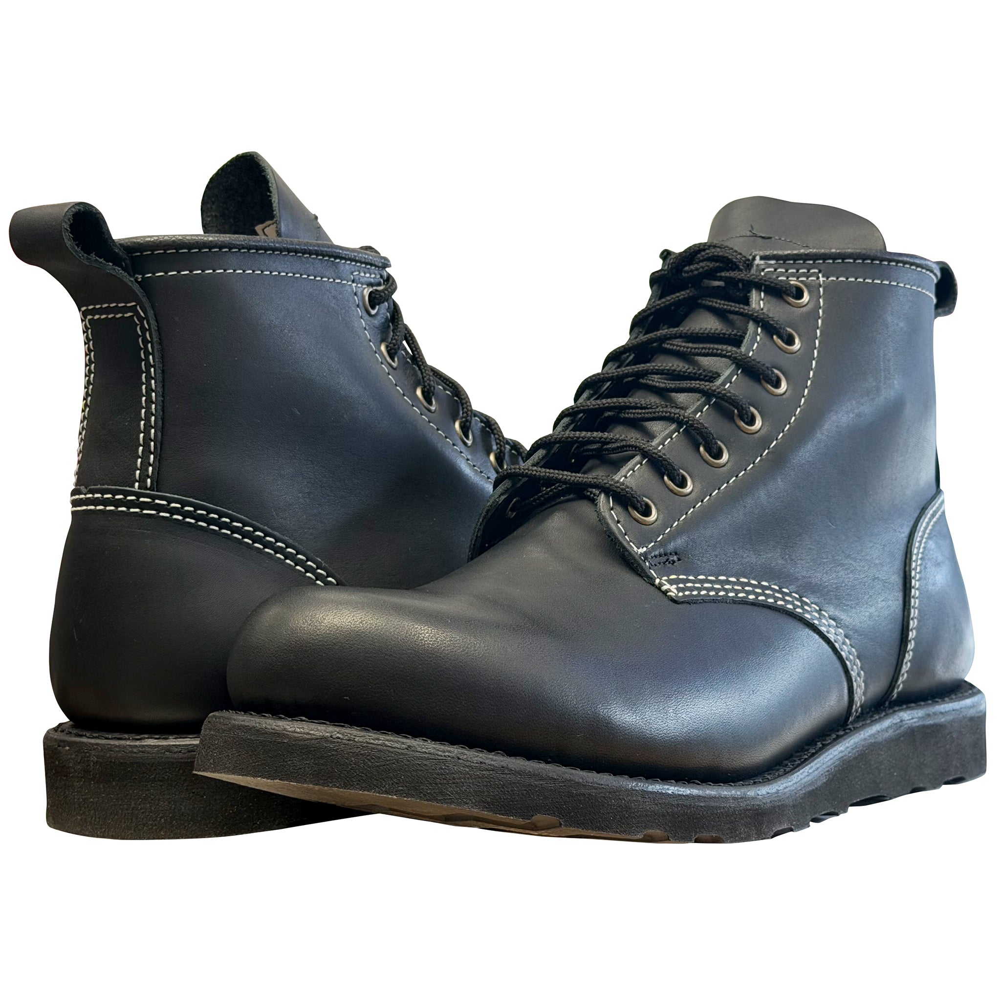 Pair of black leather boots on a white background