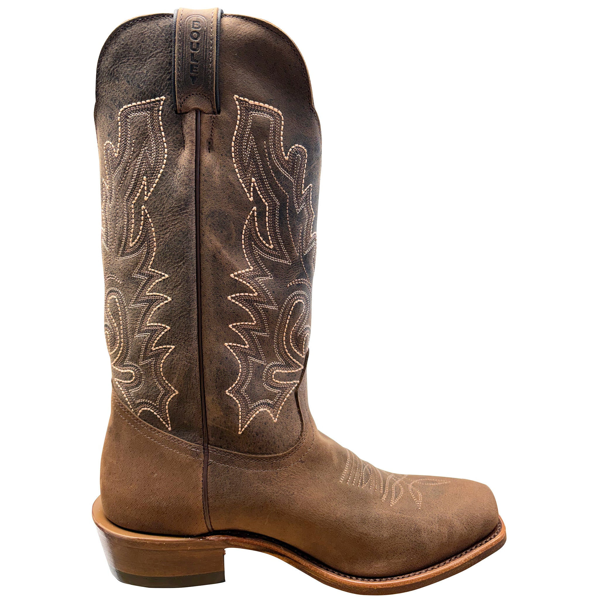 Brown cowboy boot with intricate stitching on a white background