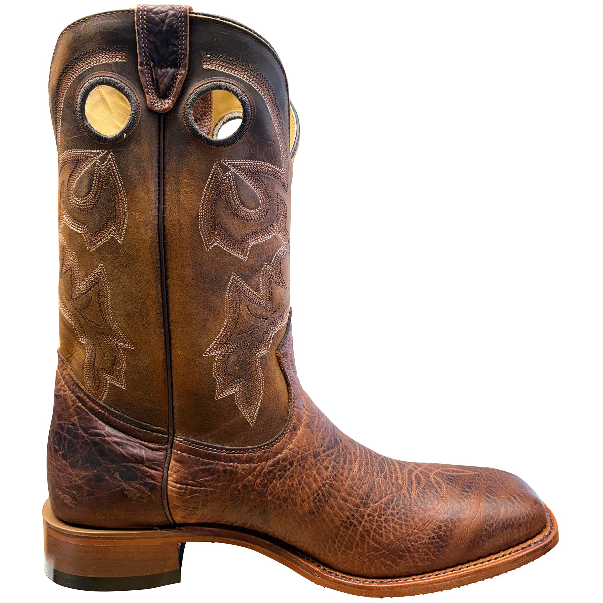 Brown cowboy boot with intricate leatherwork on a white background