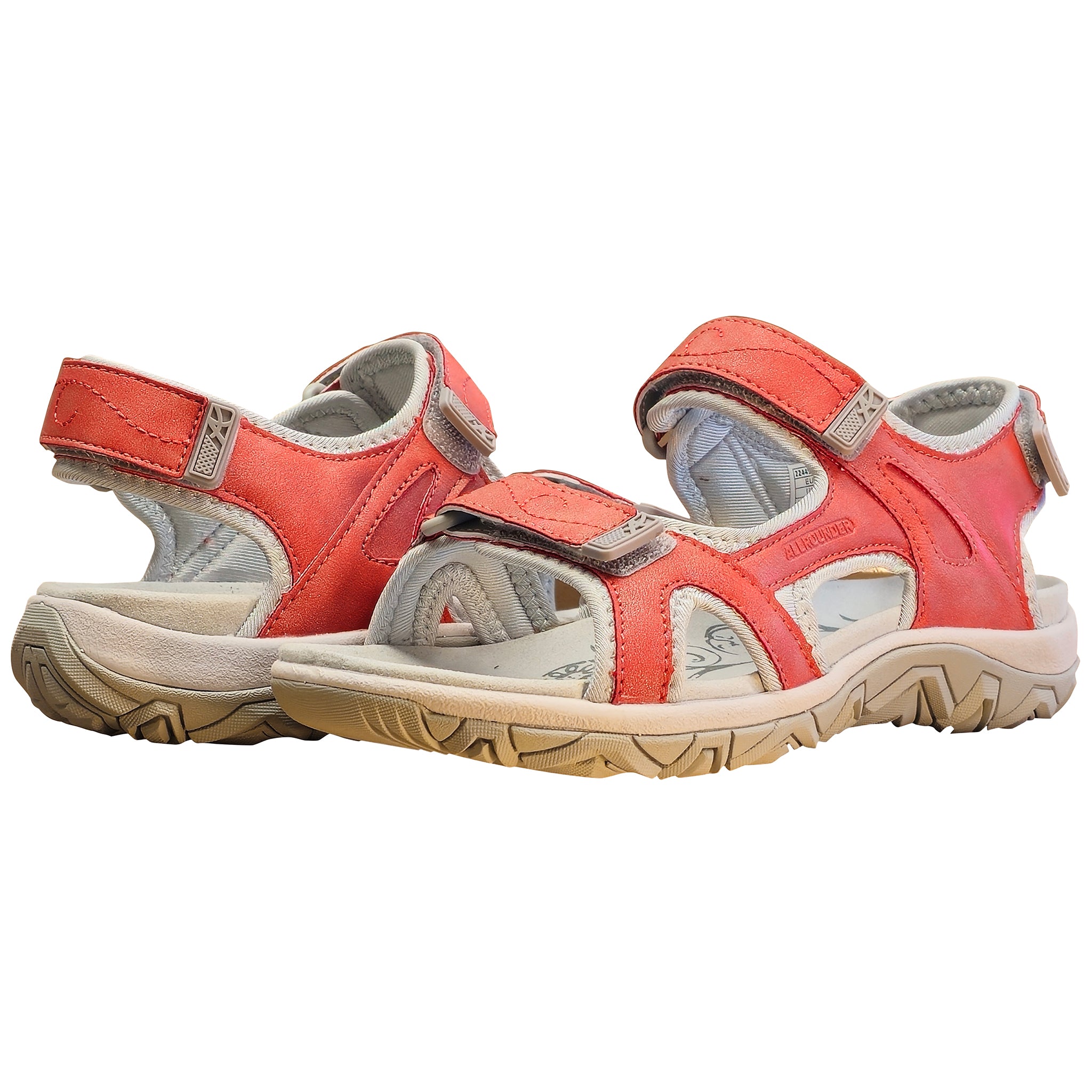 Pair of red sandals with beige soles on a white background