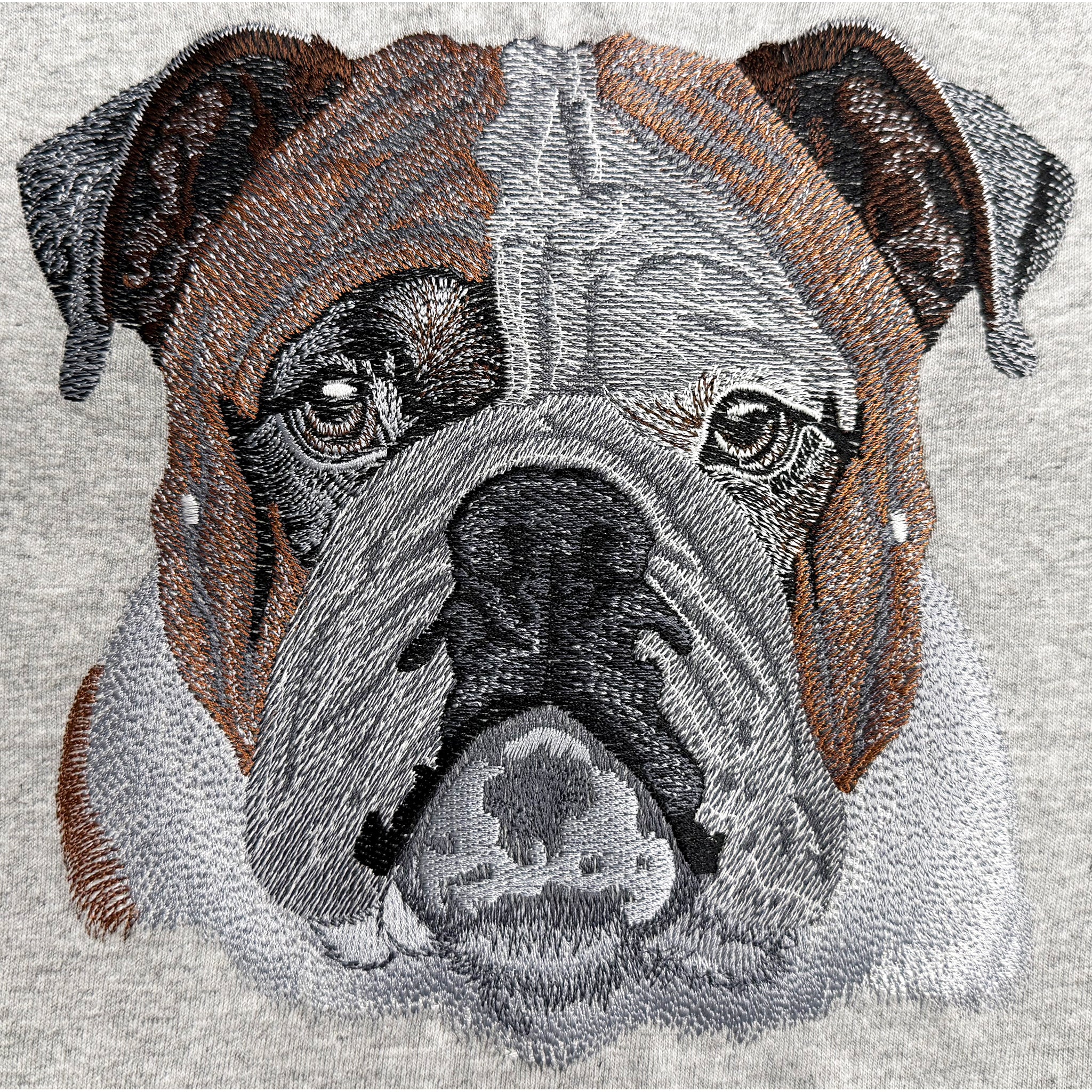 Embroidered design of a bulldog's face on a gray background