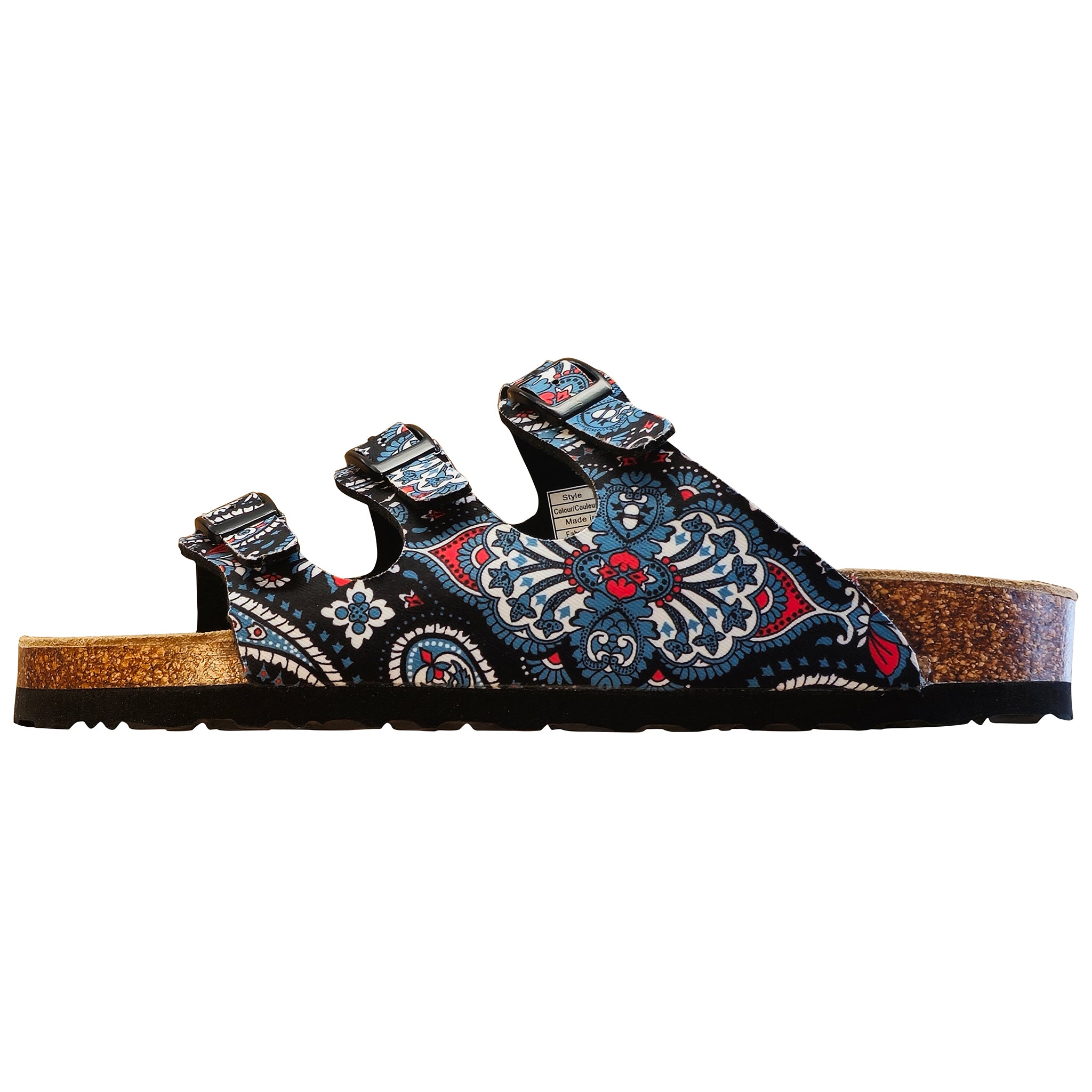 A single slip-on sandal with three adjustable straps, featuring a black upper covered in a detailed blue, red, and white paisley pattern, with a natural cork midsole and black outsole, shown against a plain white background.