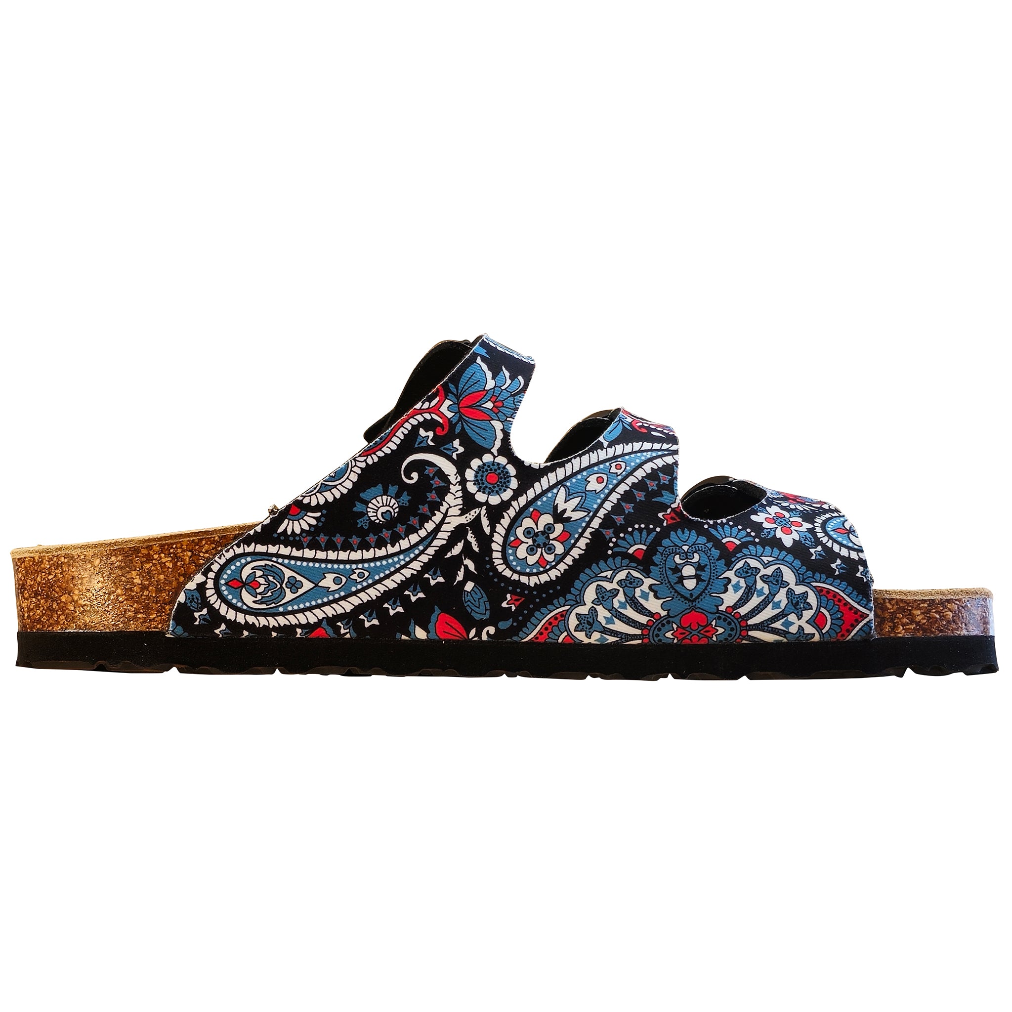 A single slip-on clog sandal featuring a black upper covered in a detailed blue, red, and white paisley pattern, with a natural cork textured footbed and a black outsole.